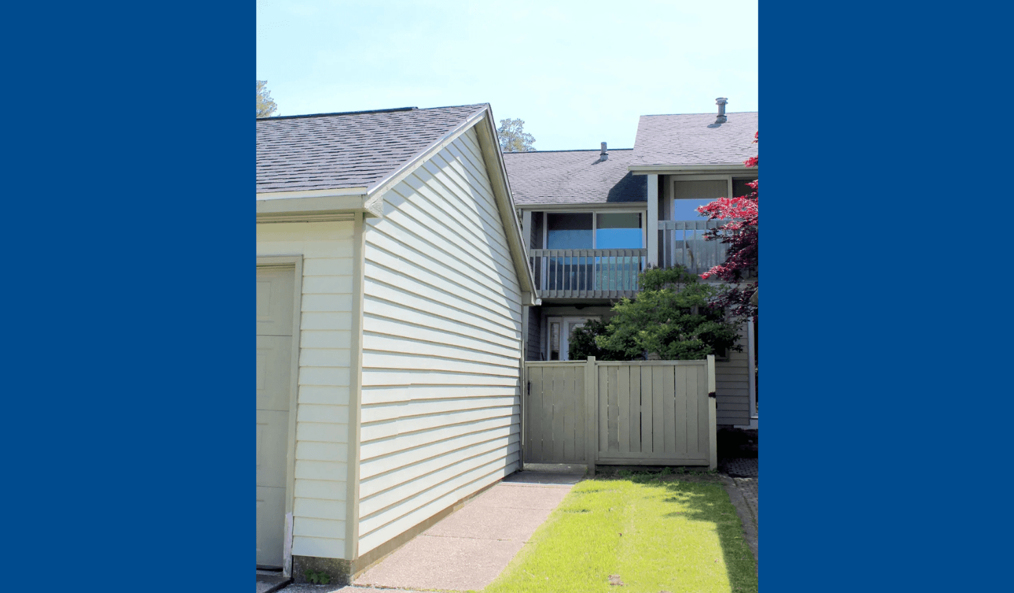 A house with a grey roof and a white siding wall.